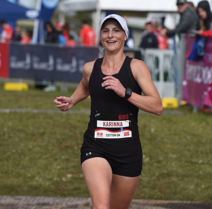 ALL SMILES: Melbourne girl Karinna Fyfe crosses the line to win the female division of the 12km event on Sunday. She clocked a time of 41:42min.