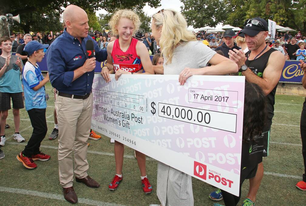 SHOW ME THE MONEY: Liv Ryan is presented with a $40,000 cheque after leading all the way in the final from her handicap of 11m.