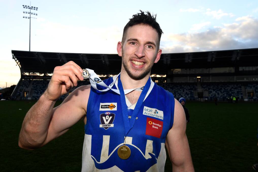 STAR PLAYER: Jams Lukich shows off the best on ground medal he won on Saturday in the Roos' grand final triumph over Hepburn. Picture: Adam Trafford.