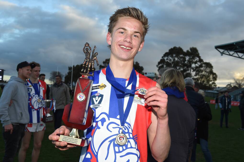 THAT TRIUMPH: A young Harry Sharp with the spoils of grand final day while playing for East Point back in 2018.