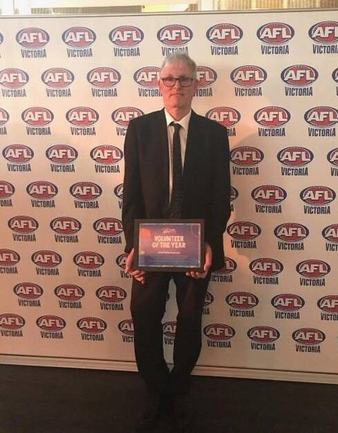 ACKNOWLEDGED: Stephen Walsh is pictured with the Victorian award he won which led to him being named the 2020 AFL Auskick Volunteer of the Year.