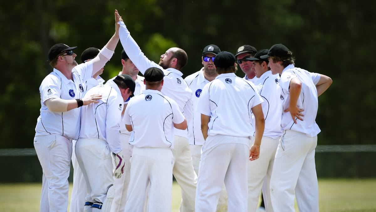 GOT HIM: North Ballarat players celebrate a wicket during a day in the field at Mt Clear 2. The Roosters fell one wicket short of claiming their first win of the season.