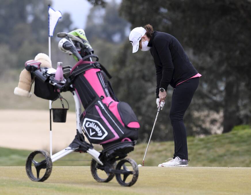 MASKING UP: Sharon McCuskey plays a shot at the Ballarat Golf Club during August. Golf restrictions are expected to be eased around regional Victoria.