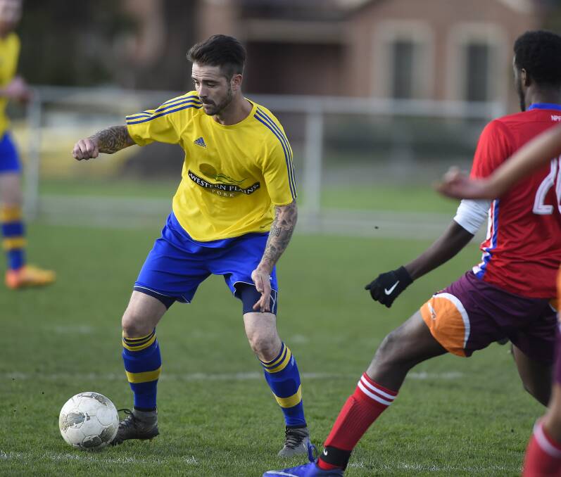 IN POSSESSION: Paul McClounan holds the ball during Saturday afternoon's victory against Newmarket Phoenix at St Georges Reserve.