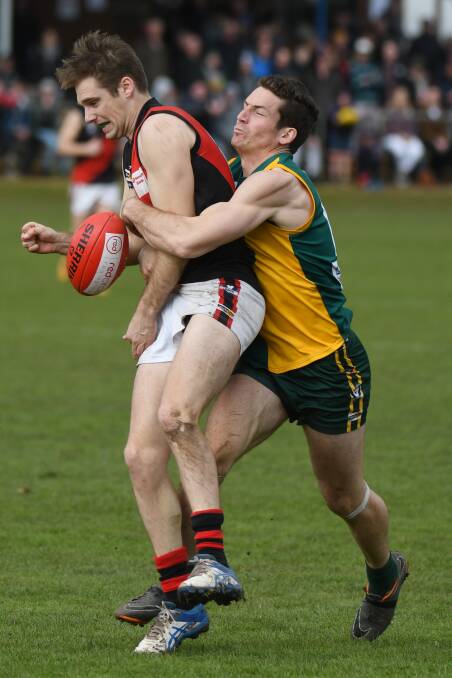 TACKLE: Gordon's Luke Gunnell captures Buninyong rival Isaac Baker on Sunday. The Bombers are now chasing their first flag since 2002.