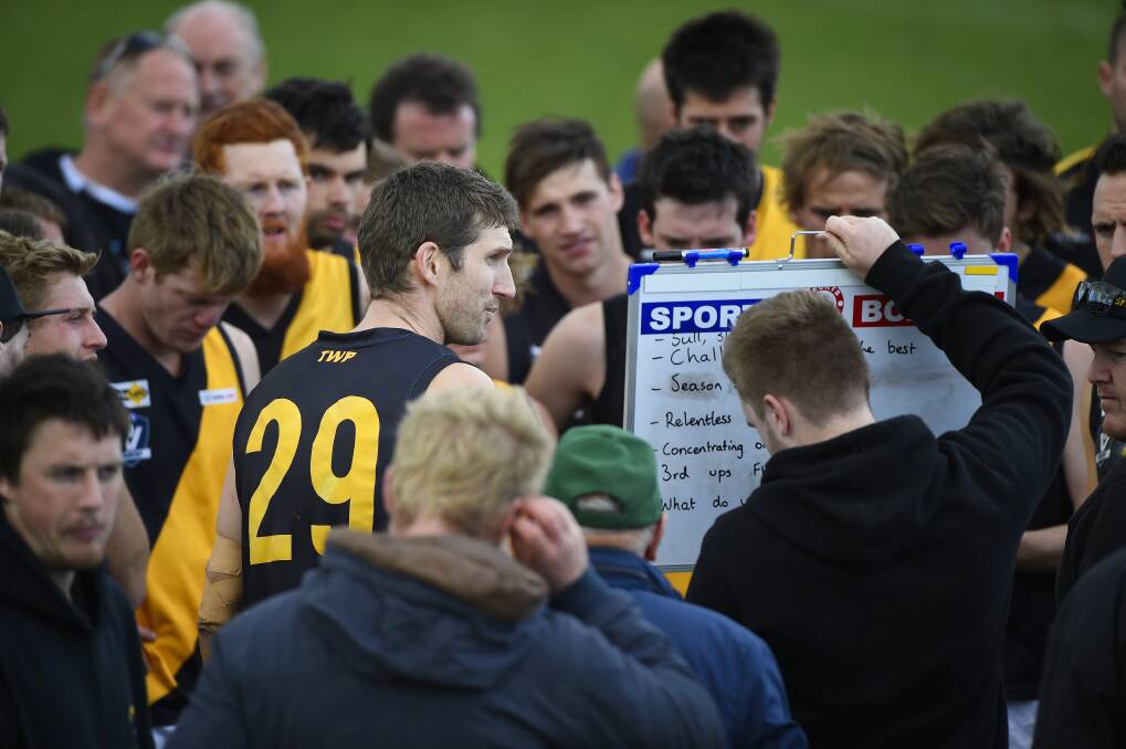 TAKING CHARGE: Springbank joint-coach Michael Searl speaks to his players on Sunday during the clash against Bungaree. Picture: Luka Kauzlaric.