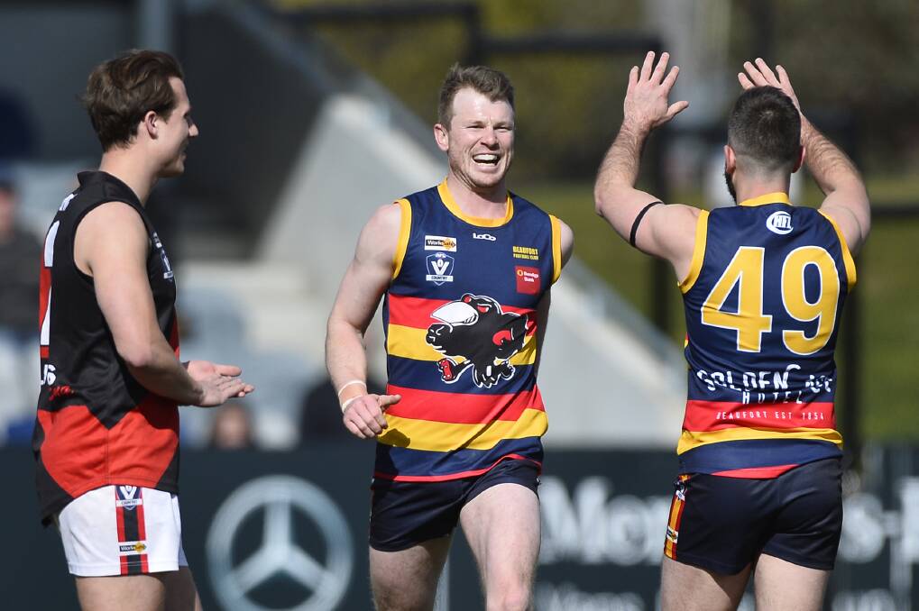 ALL SMILES: Beaufort forward Tim Haase celebrates a goal with teammate Daniel Venditti. The Crows kicked clear in every quarter to win by 38 points.