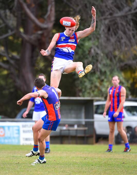 Daylesford coach Zac Tisdale flies for a mark.