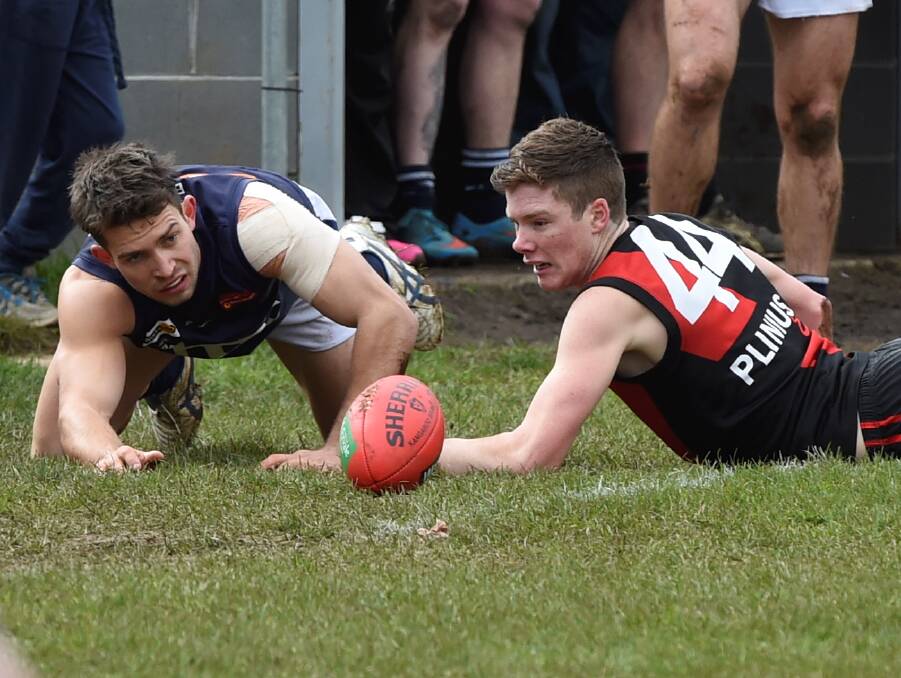 OUT OF BOUNDS: Jackson Kew (Ballan) and Damian Hamm (Buninyong) watch on as the ball rolls out for a boundary throw-in.