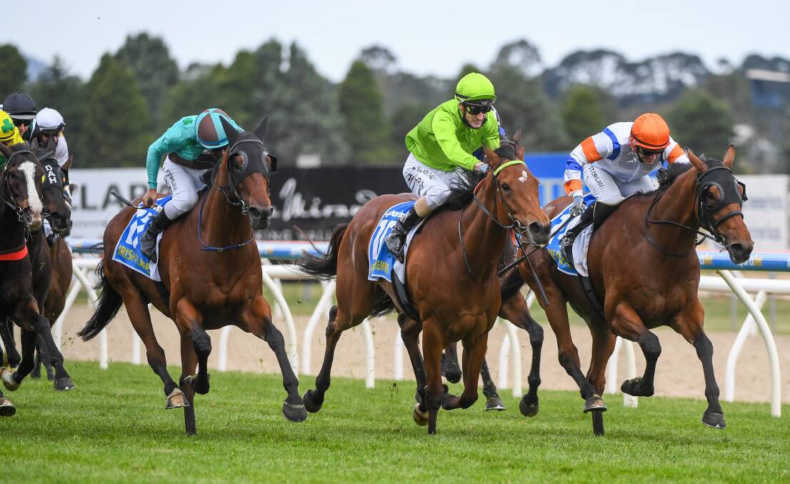FLYING HOME: Mark Zahra and Affair To Remember burst through late between eventual winner Irish Flame (left) and third-placed Game Keeper (right). Picture: Racing Photos.