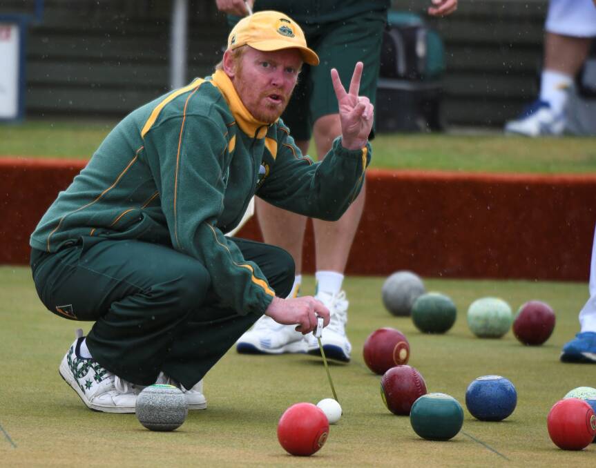 THAT'S TWO: Lara bowler Leigh Hanlon signals to a teammate during Saturday's Geelong-Ballarat Premier Bowls clash with Sebastopol. Lara won the fixture by 16 shots. Pictures: Lachlan Bence.