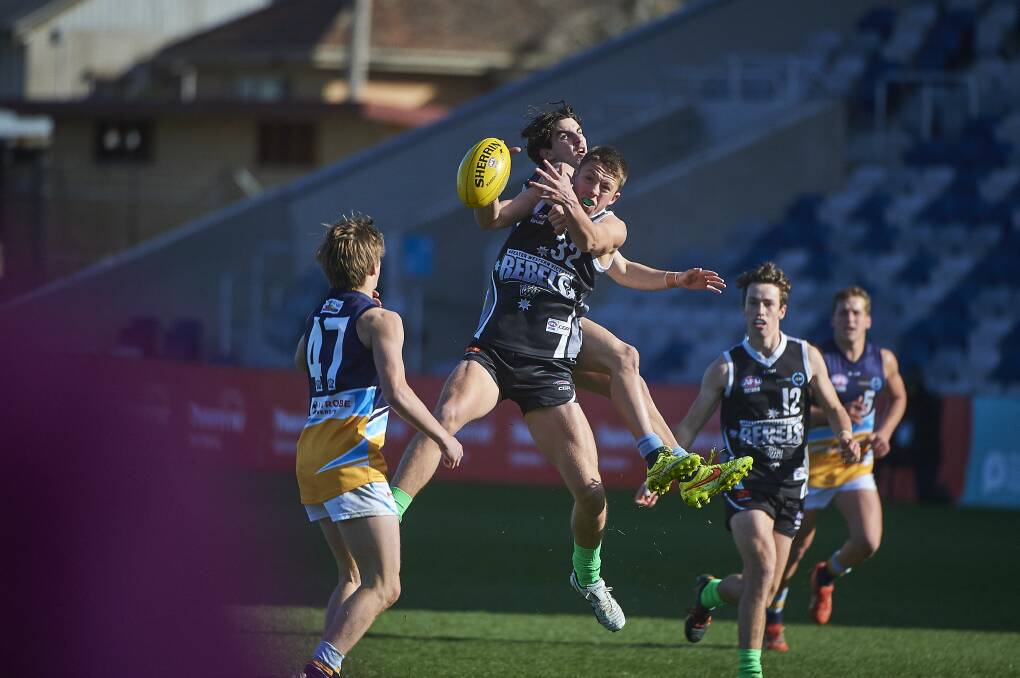 CONTEST: The Rebels' Mitchell Burgess is pictured trying to mark during Saturday afternoon's match against the Bendigo Pioneers at Mars Stadium. Picture: Luka Kauzlaric.