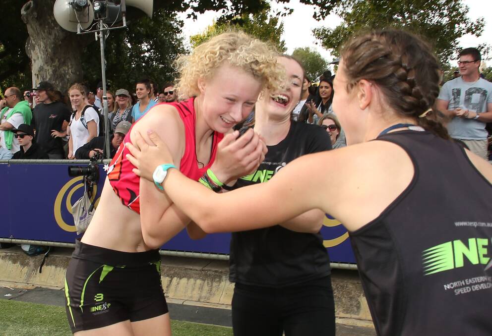 CELEBRATIONS: Liv Ryan is mobbed by friends after sprinting to victory in the rich Stawell Women's Gift at Central Park.