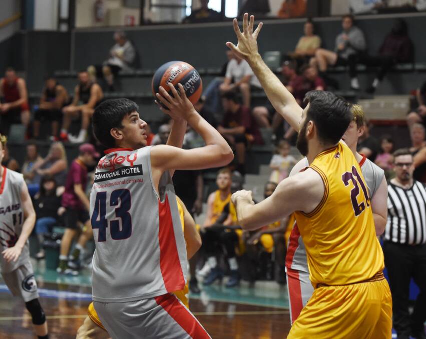 BLOCK: Sin Djuric (Melton Thouroughbreds) looks to stop Sam Koch (Keysborough Red) from shooting. Pictures: Kate Healy.