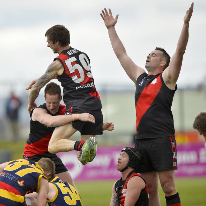 PREMIERS: Buninyong players celebrate at the final siren of last year's reserves grand final.