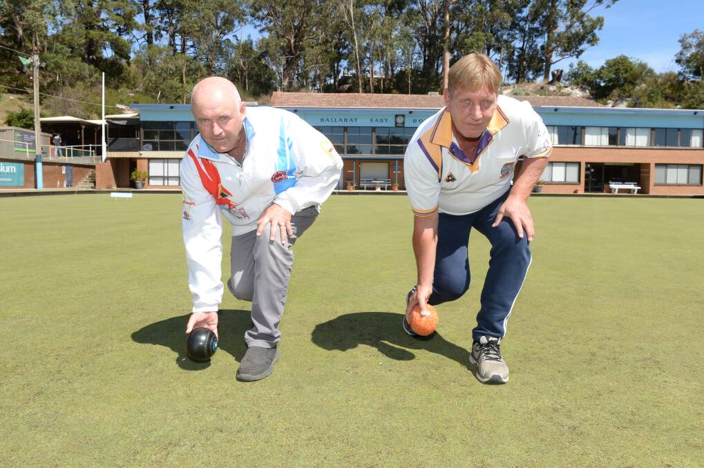 FRIENDS AND FOES: BMS bowler Graeme Inglis and Learmonth's David Pike get a feel for the Ballarat East green. Picture: Kate Healy.