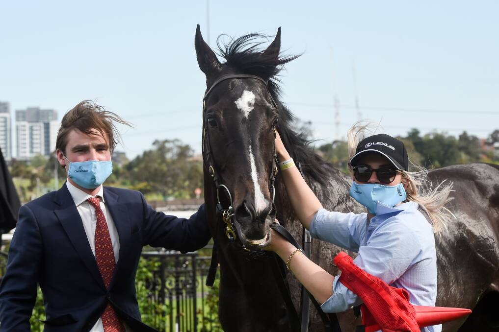 BIG WIN: Trainer David Eustace and track rider/strapper Nikki White with Persan after his win in The Bart Cummings early this month. Picture: Racing Photos.