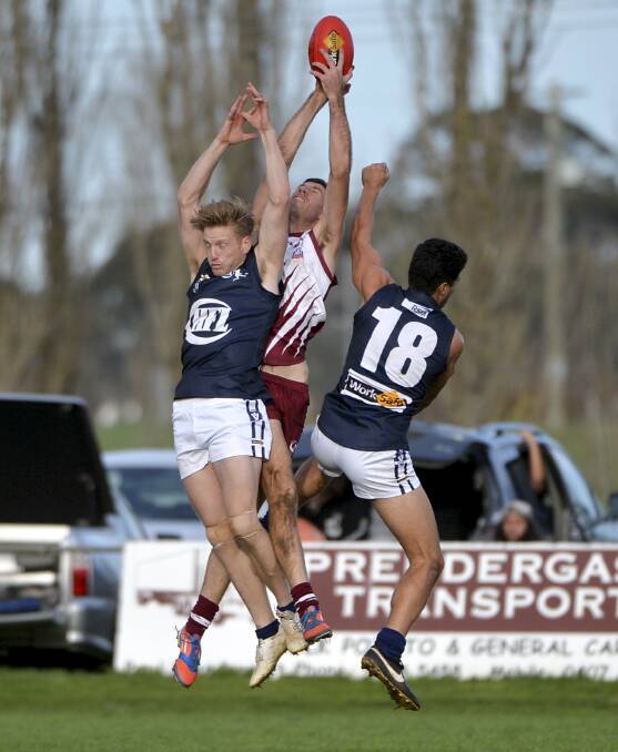 TALL TARGET: Geelong and District's Jason Tom flies for a mark as the Central Highlands' Tom Nijam and Segifili Asa Leausa try to spoil.