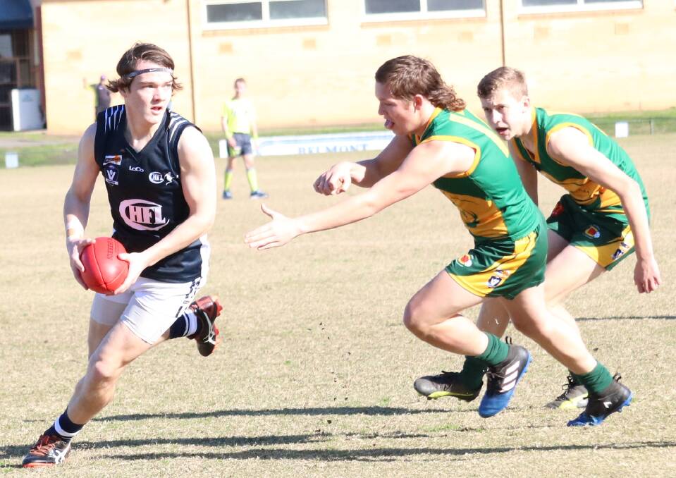 EVASIVE: Central Highlands under-15 player Daniel Pascoe (left) is pictured in action against the Colac and District side on Sunday.