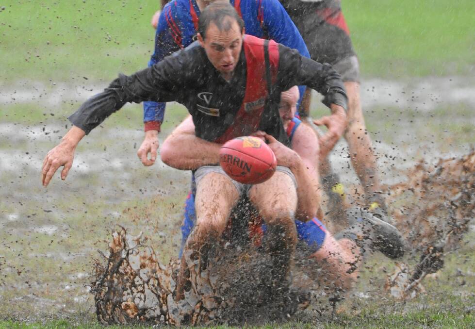 AN EPIC BATTLE: Buninyong's Billie Leskosek is tackled during a wet preliminary final at Learmonth back in season 2010. The Burras won the clash by 23 points.