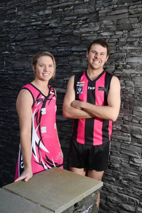 Clunes players Madison Davis and Lachy Wrigley show off the new pink designs which will be worn during Saturday's matches against Dunnstown. Picture: Kate Healy.