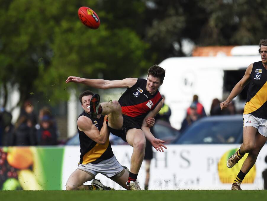 HIGH PRESSURE: Buninyong forward Joel Ottavi gets a kick away as he is slung to the ground on Saturday. Ottavi finished the day with four goals.