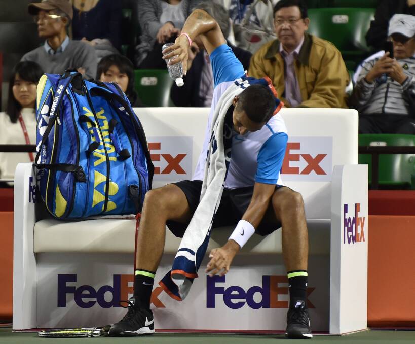 DUMMY SPIT: Another water bottle about to fall victim to Nick Kyrgios' anger in Japan last week. His tirades are getting tiring. Pictures: Getty Images.