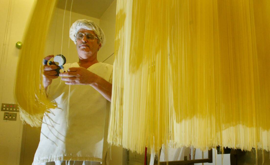 PRECISION: Flash back to 2004, production operator Jeff Zala measures the thickness of the noodles being made at the Hakubaku in Wendouree. Picture: Paul Harris