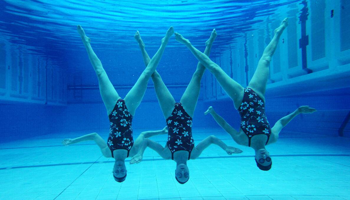 UNDERWATER: Melbourne Commonwealth Games synchronised swimming team Luda Plotnikova, Dannielle Liesch and Irena Olevsky.  Picture: Vince Caliguiri
