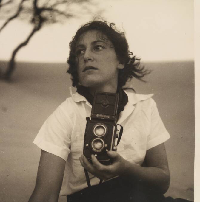 Olive Cotton holding a camera. Picture: Courtesy of the NSW State Library.