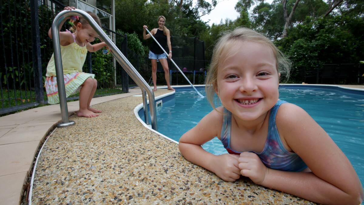 Fun in a backyard pool that meets all the requirements as mum supervises.