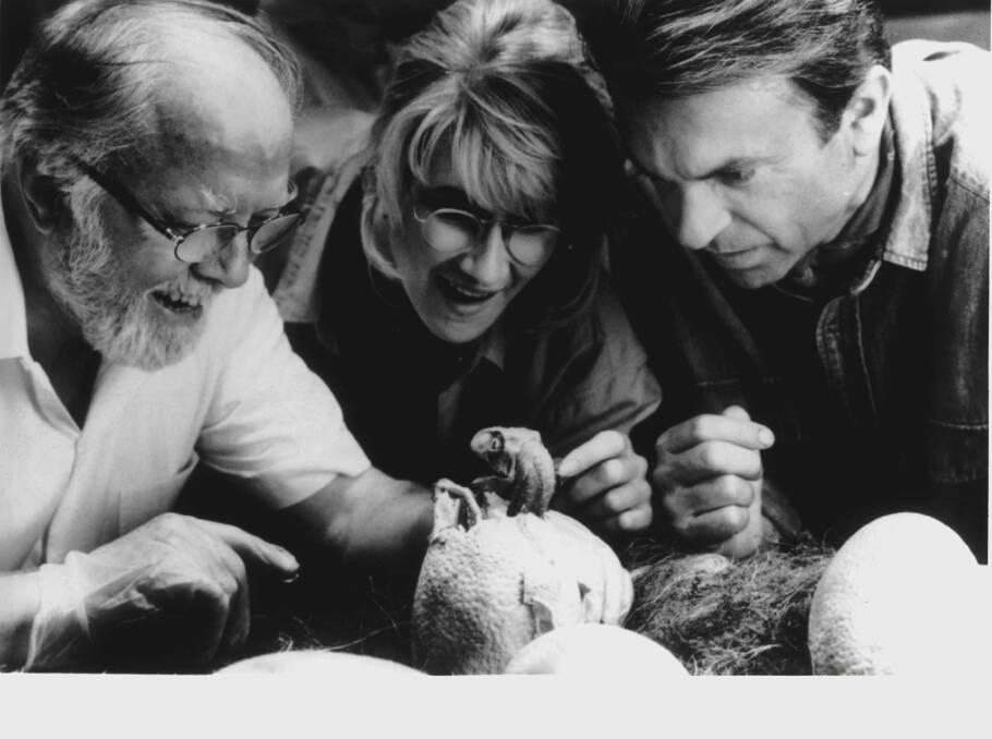Richard Attenborough, Laura Dern and Sam Neil look over a baby dinosaur in "Jurassic Park". Picture: AAP