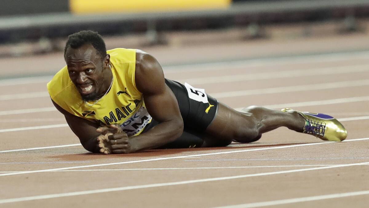 END: Jamaica's Usain Bolt lies on the track after he injured himself in the 4x100m relay final, his final race,  at the World Athletics Championships in 2017. Picture: AP
