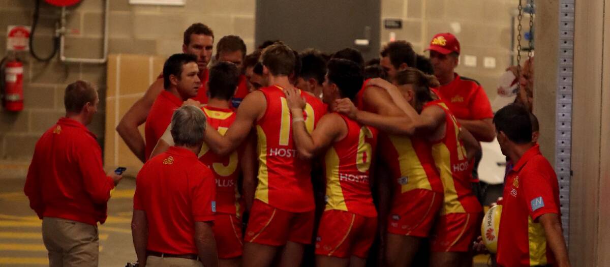 IN TIGHT: Gold Coast Suns huddle in close before entering the playing arena against Adelaide at Adelaide Oval last weekend. Picture: Kelly Barnes, AAP