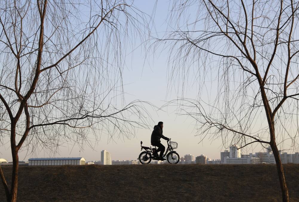 A man rides an electric bike in Pyongyang, North Korea. Picture: AP/Dita Alangkara