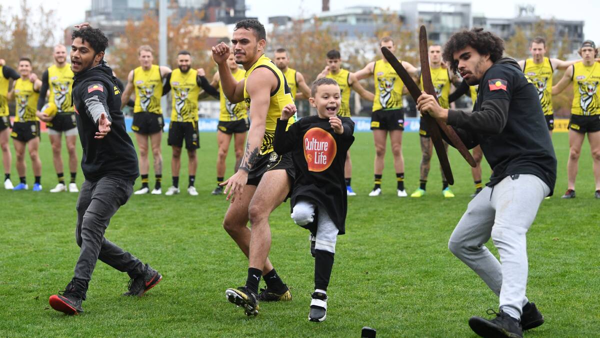 PROUD: Richmond's Sydney Stack performs a war cry with members of the Korin Gamadji Institute after a training session at Punt Road Oval last month. Stack wants to be an indigenous role model. Picture: AAP