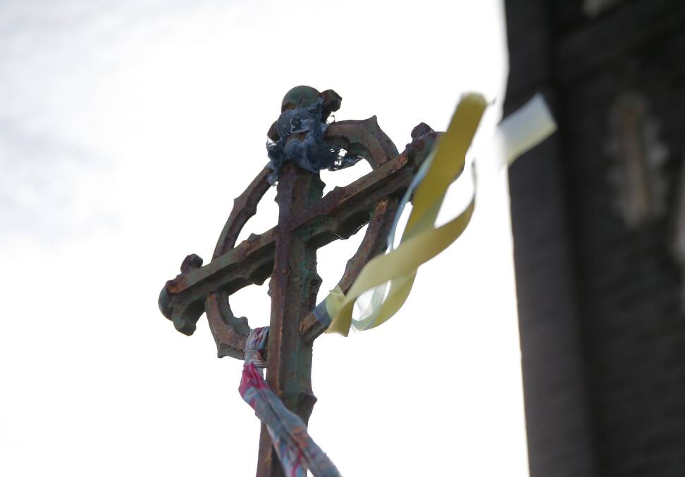 Loud fence: Ribbons are attached to Catholic church fences in support of clergy abuse victims.