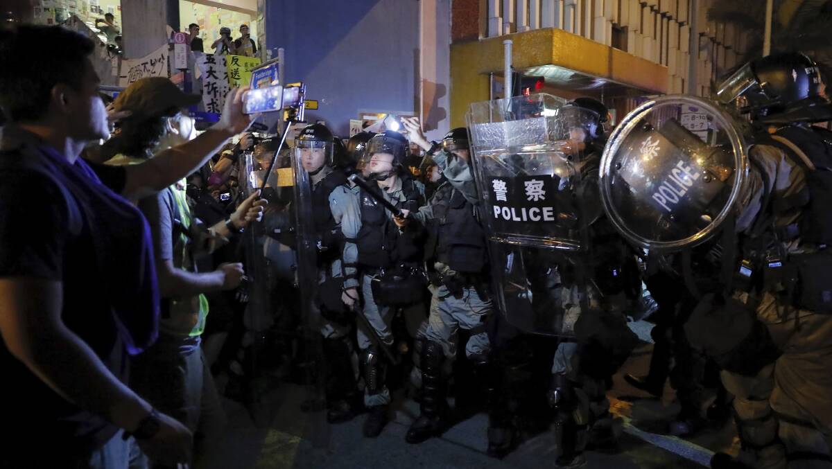 Riot policemen face off with protesters over the anti-extradition bill in Hong Kong. Picture: AP