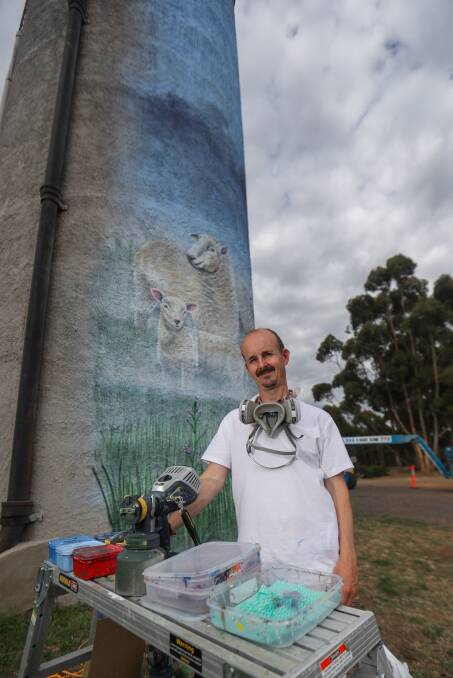FINISHED: Jimmi Buscombe has painted native animals, including sheep and a 12-metre tall brolga on a water tower at Lismore. Picture: Morgan Hancock