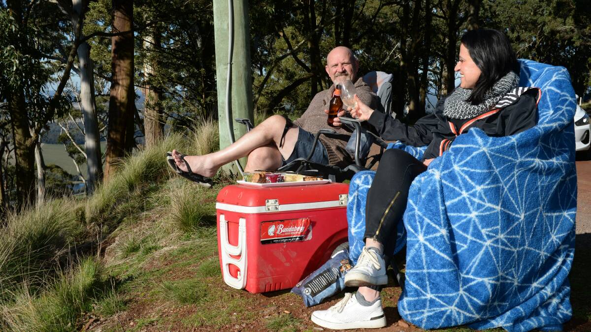 SUNNY DAYS: Chris and Susan Anstis from Alfredton made the most of the winter sun, enjoying a picnic at Mount Buninyong. Picture: Kate Healy