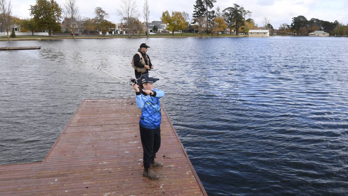Shane Stevens and his son Max dangle a line into Lake Wendouree.
