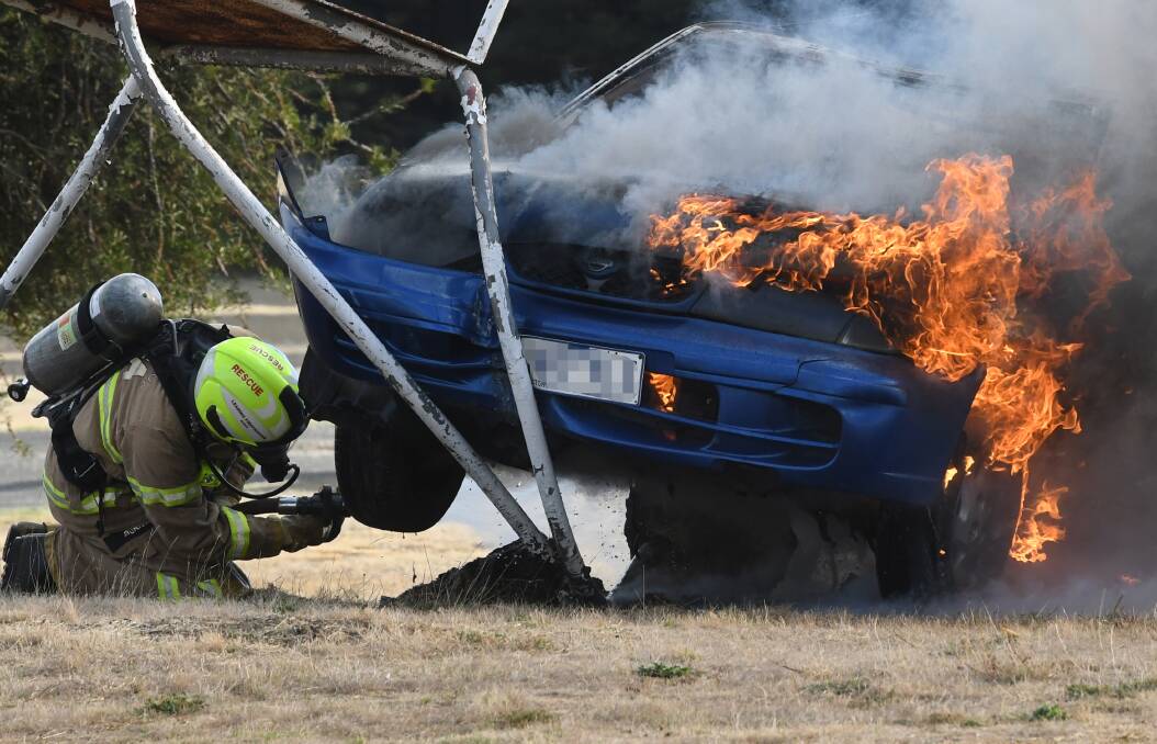 DANGEROUS WORK: Fire fighters were called out on Saturday morning to a car fire which happened near the airport at Mitchell Park. Picture: Lachlan Bence