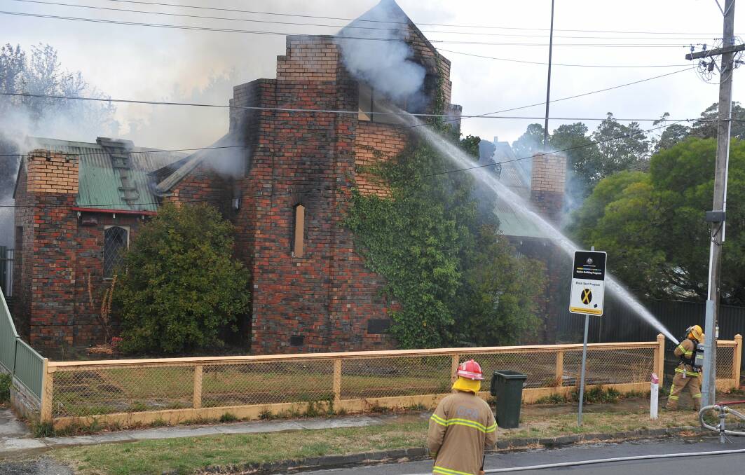 GUTTED: Fire fighters work to save the historic church which went up in flames on Thursday at Mount Pleasant. Picture: Lachlan Bence