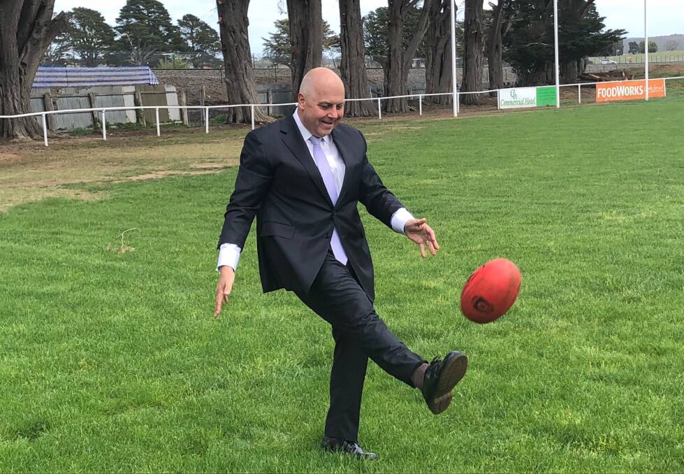 Treasurer Tim Pallas has a kick on the Ballan Recreation Reserve, one of five grounds to benefit from the loans package. Picture: Greg Gliddon