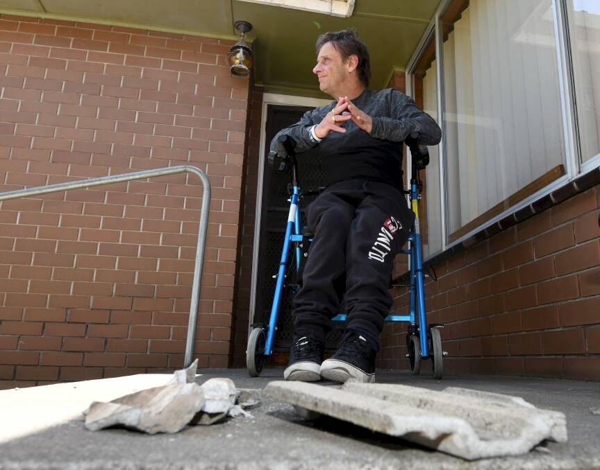 Glenn Sutton narrowly avoided being hit when tiles were blown off the roof of a Norman Street house. Picture: Lachlan Bence