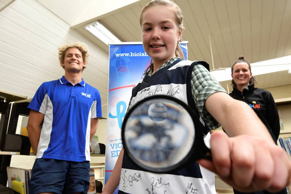 HAPPY CAT: Sam Dangerfield, Grade 6 Student Bella Davies and Shannon Gleeson after Bella won a signed Geelong jumper through Biolab. Picture: Lachlan Bence.