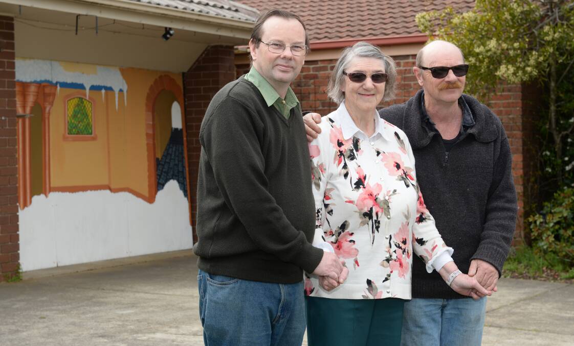 Chris, Margaret and David Tong hope for a Christmas Miracle to get the lights up again this year. Picture: Kate Healy