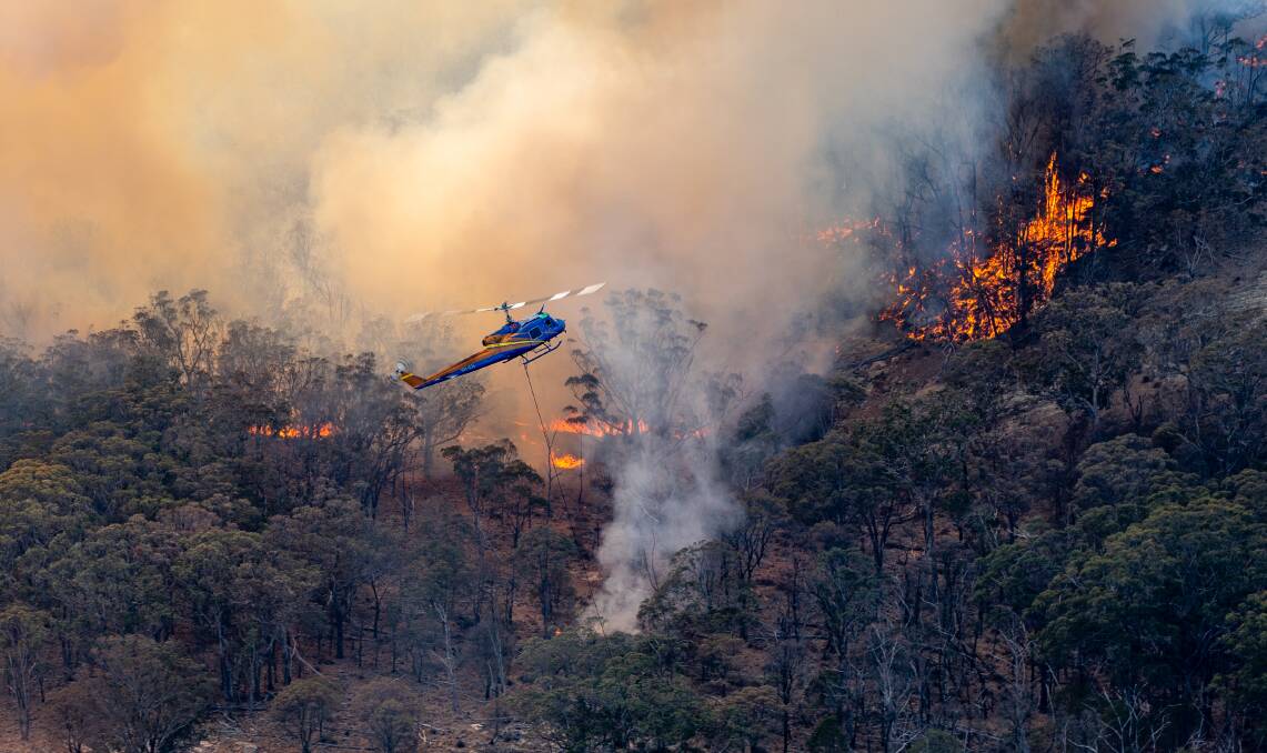 FIRE BOMB: Almost 30 aerial bombers have been attacking the New South Wales bushfires from the sky. Picture: RFS/Ned Dawson