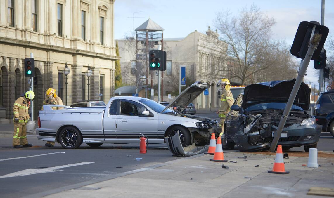 LUCKY ESCAPE: A traffic light was destroyed after two cars crashed at the corner of Sturt Street and Armstrong Street South late on Saturday afternoon. Picture: Luka Kauzlaric