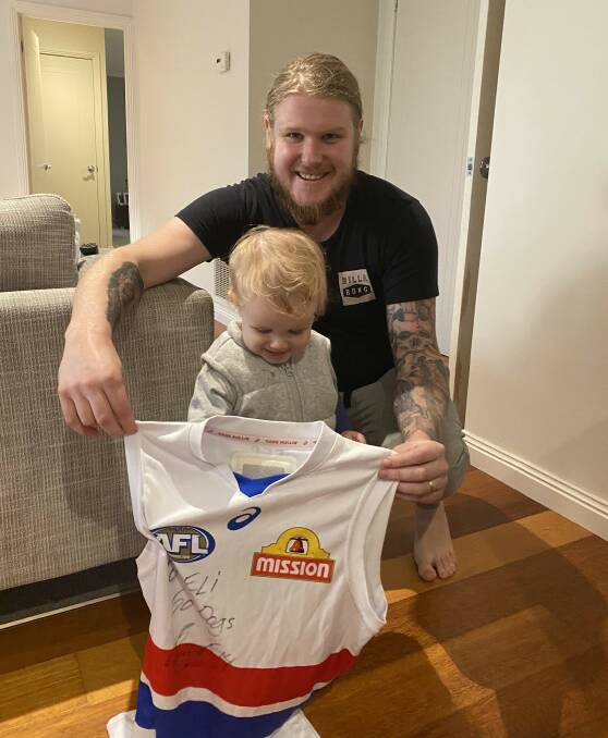 Brad Judd and his son Eli with Clay Smith's personally signed jumper. Picture: supplied